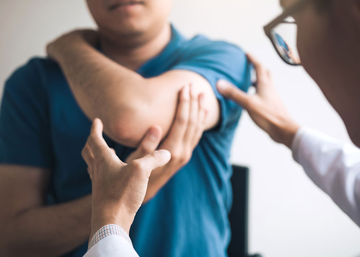 Doctor treating patient with auto accident injuries