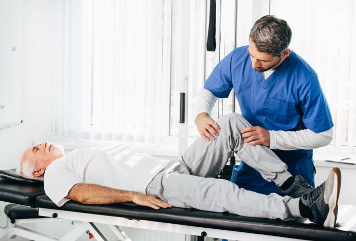 Doctor examining a patient with a knee injury