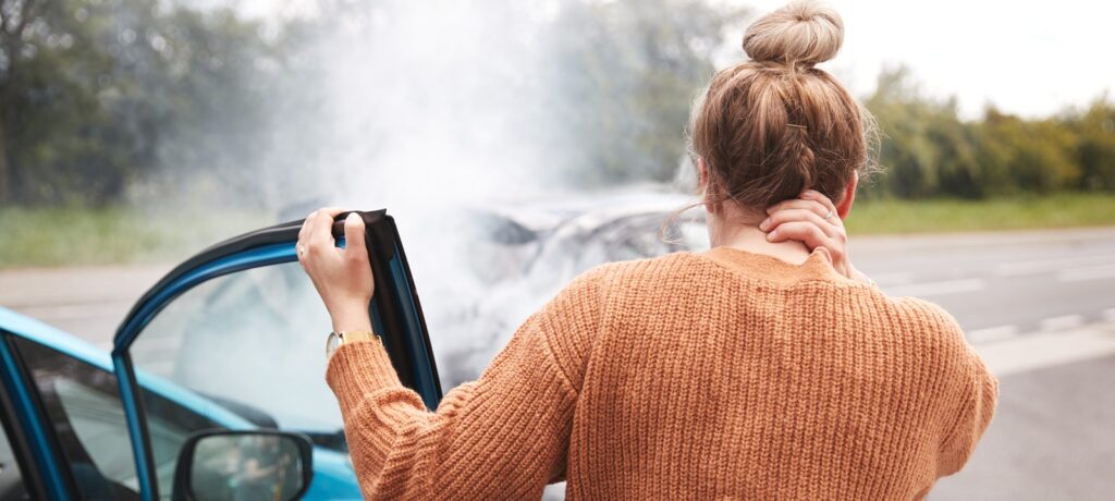 woman exiting her car after an auto accident