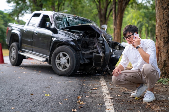 Man on cell phone after a care accident