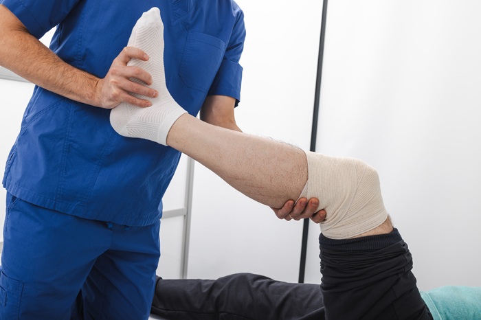 Pain doctor treating knee injury